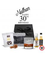 Whiskey gift boxes with engraved 30th birthday tumbler glass and snacks.