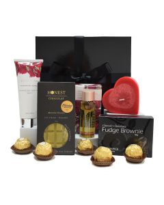 Chocolates, love heart candle and beauty product gift boxes for women.