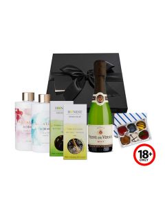 Pamper hamper with chocolates, beauty products and a bottle of bubbles.
