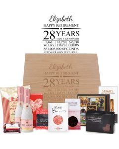 Luxury retirement gift boxes with gourmet treats, bottles of bubbles and a personalised laser engraved timeline design.