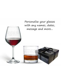 tumbler glass and wine glass both engraved with any text, positioned in front of a black gift box with a satin bow