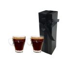 Personalised glass cup that can be used for any hot drink. Engraved with any message, this picture shows two cups standing in front of a tall and thin black box with a white background