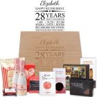 Luxury retirement gift boxes with gourmet treats, bottles of bubbles and a personalised laser engraved timeline design.