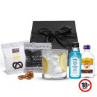 Gin gift set with short tumbler glass and gourmet treats.