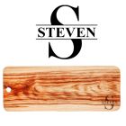 Wood grazer food serving boards engraved with a person's name and initial.