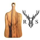 Engraved personalised food serving paddle board with stag head design and two initials.